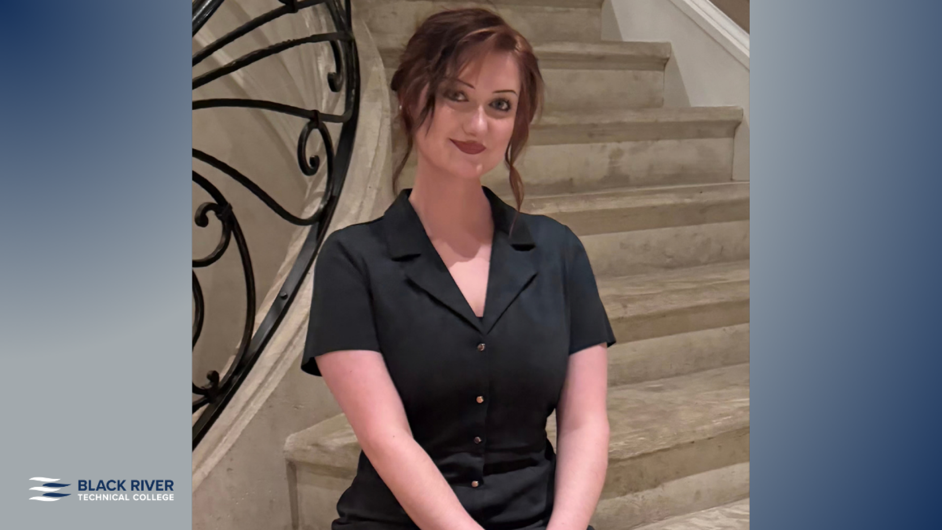 A young woman with reddish-brown hair styled up, wearing a dark button-front top, sits on a staircase with an ornate iron railing, with Black River Technical College branding.